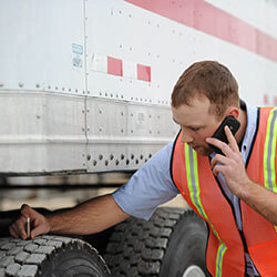 Person checking truck tire tread