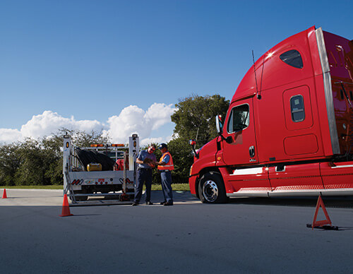 Truck receiving assistance on side of road