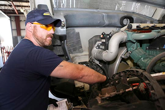Goodyear technician inspecting engine