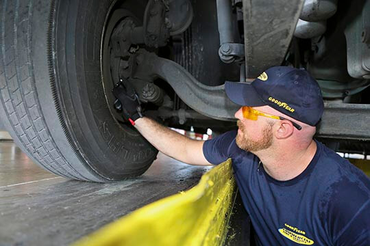 Preventive maintenance technician inspecting tire
